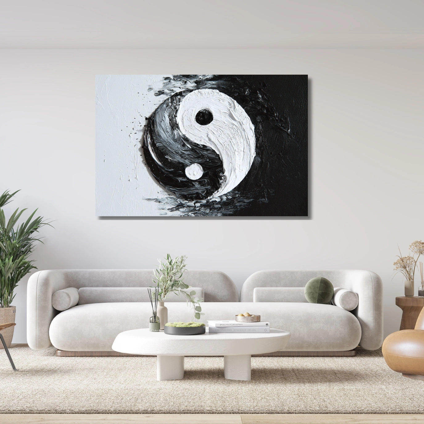 Abstract yin yang painting on a wall above a modern white sofa in a living room.