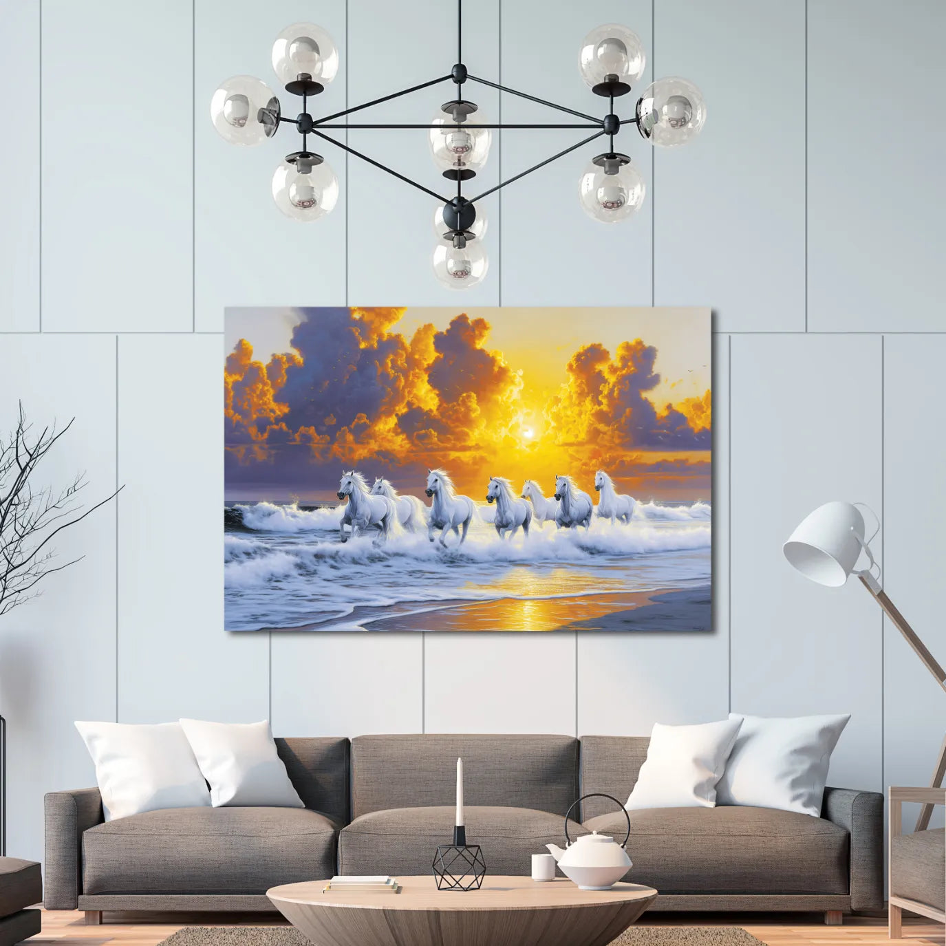 Living room with a painting of 7 horses on a beach, a modern chandelier, and a gray sofa.