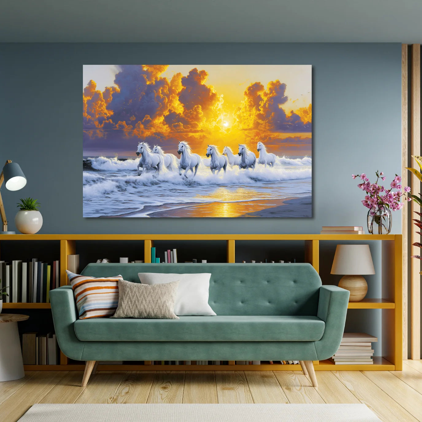 Living room with a teal sofa, bookshelf, and large wall art of 7 horses on a beach at sunrise