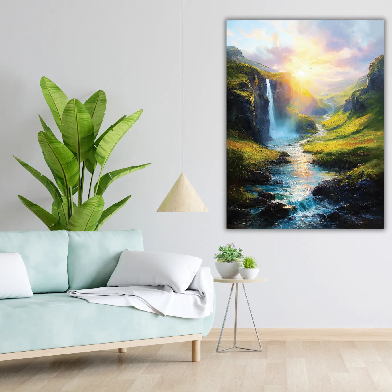 Lush green plant next to a painting of a mountain landscape with a waterfall in a living room.