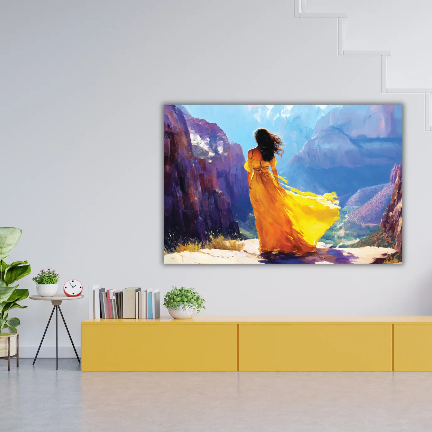 A woman painting in a yellow dress standing in a scenic landscape with mountains and blue sky, displayed on a wall.