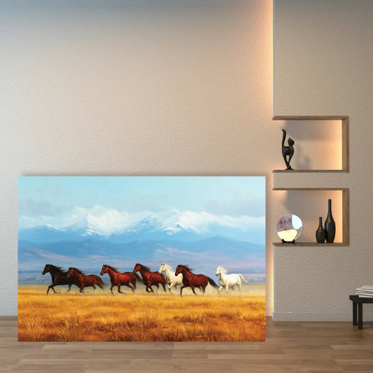 Canvas print of horses running in a field on a wall next to shelves with decorative items.